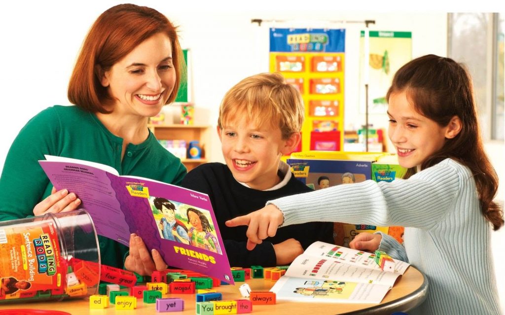 A mother reading with her children happily