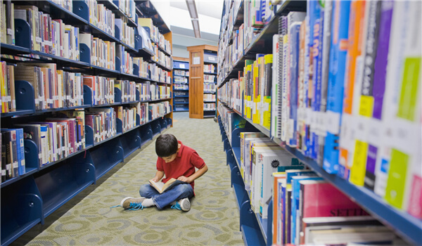 A boy reading in the library