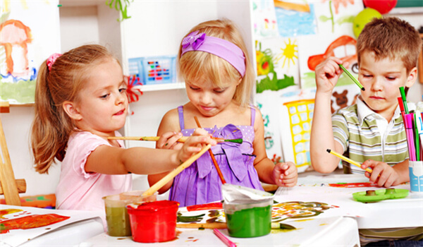 Three kids playing with painting brush 