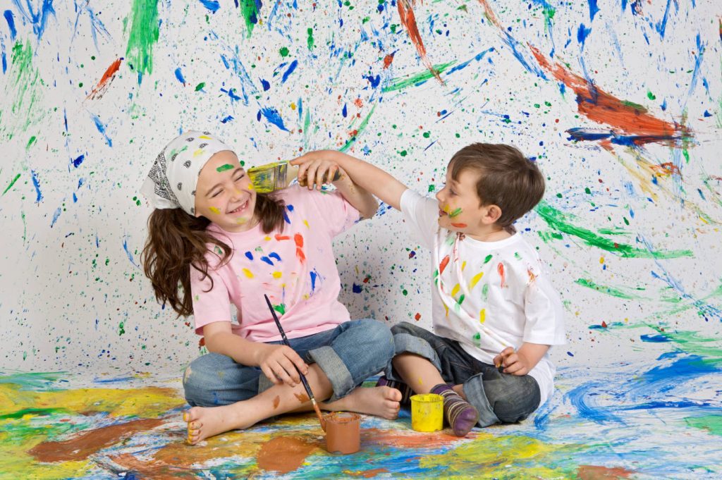Two kids playing with painting brushes 1