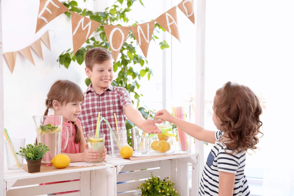 3 kids playing around the table